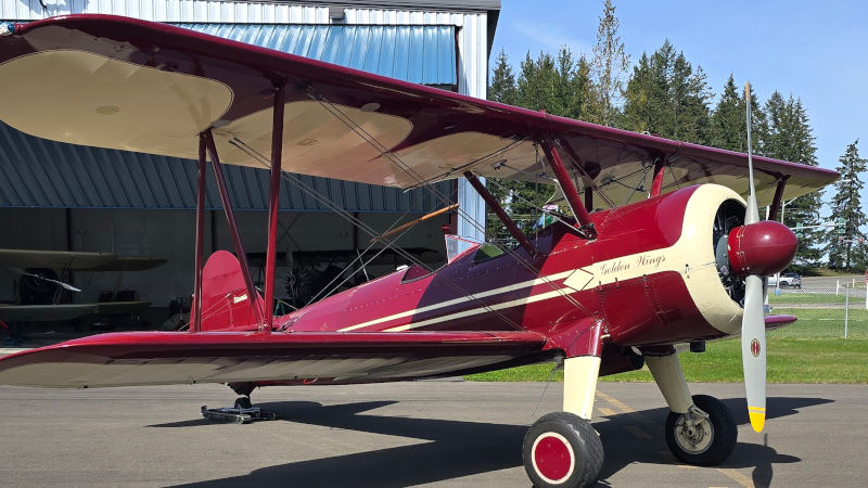 brem-2025-wingwalking-performer-page Wingwalking Bi-plane - Red and white in color. Parked outside